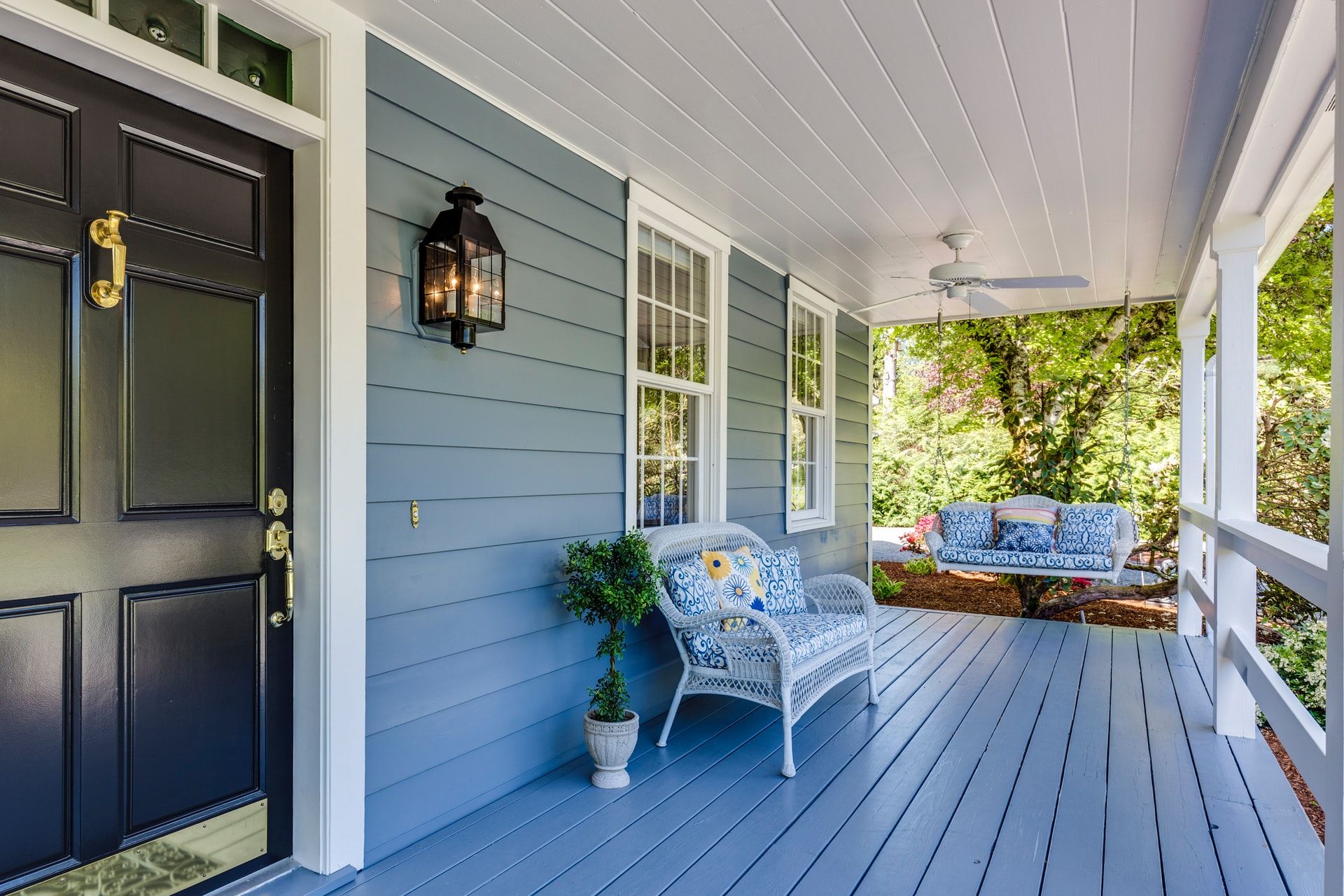 An outside porch view of a freshly painted home exterior